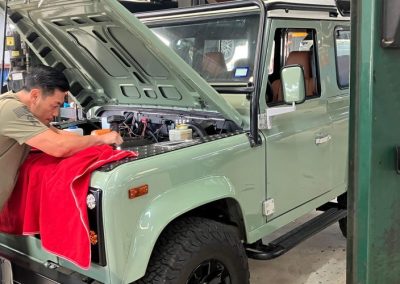 Tech servicing a Land Rover Defender 90.